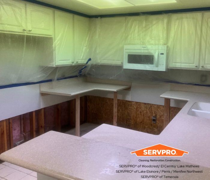 kitchen with containment on cabinets and microwave